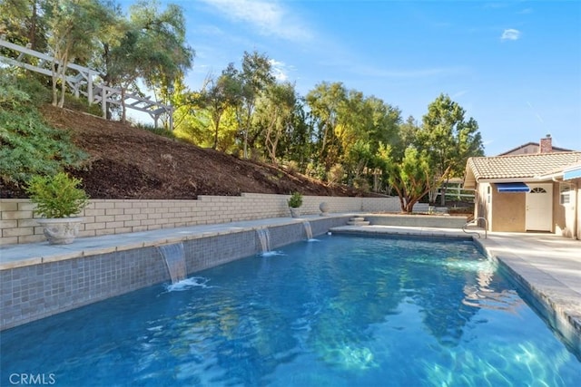 view of pool with pool water feature and a patio