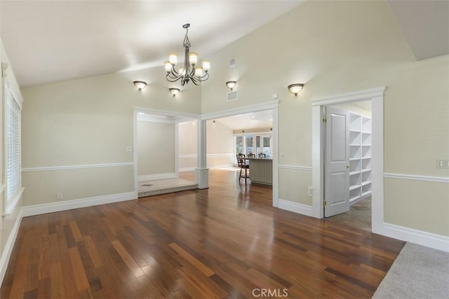 unfurnished dining area with vaulted ceiling, a notable chandelier, and dark hardwood / wood-style flooring