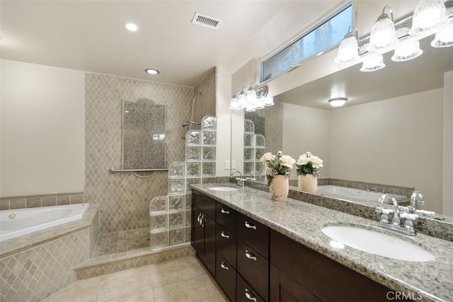 bathroom featuring vanity, tile patterned floors, and separate shower and tub