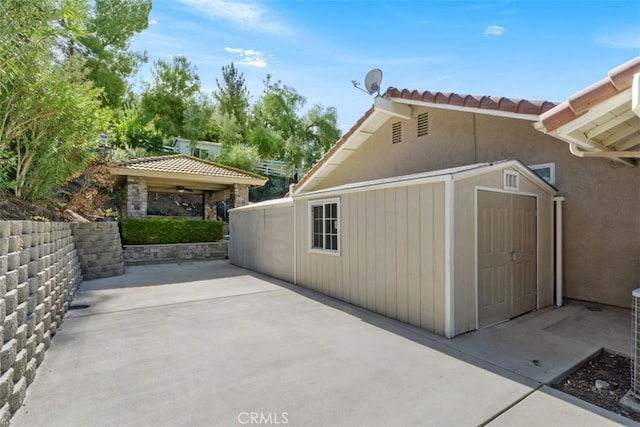 view of property exterior with a patio area