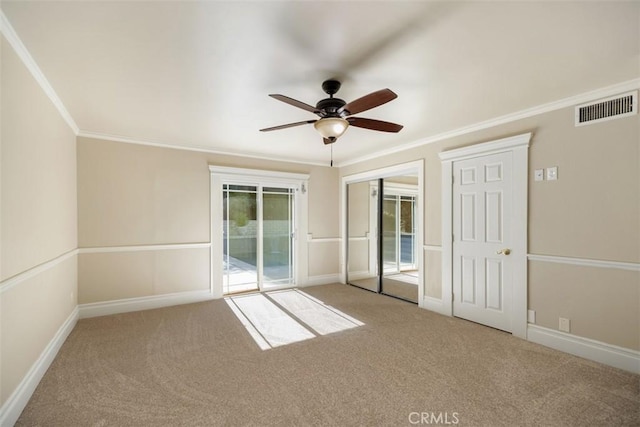 carpeted empty room with ornamental molding and ceiling fan