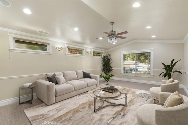 carpeted living room with crown molding, ceiling fan, plenty of natural light, and vaulted ceiling