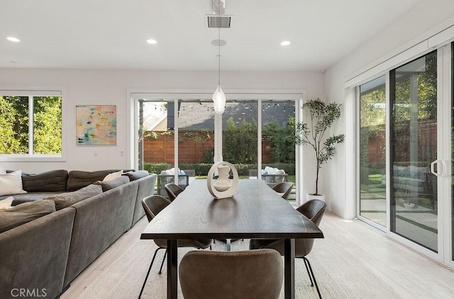 dining space with a wealth of natural light and light hardwood / wood-style floors