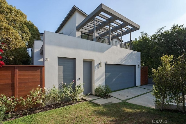 view of front of property featuring a balcony and a front yard