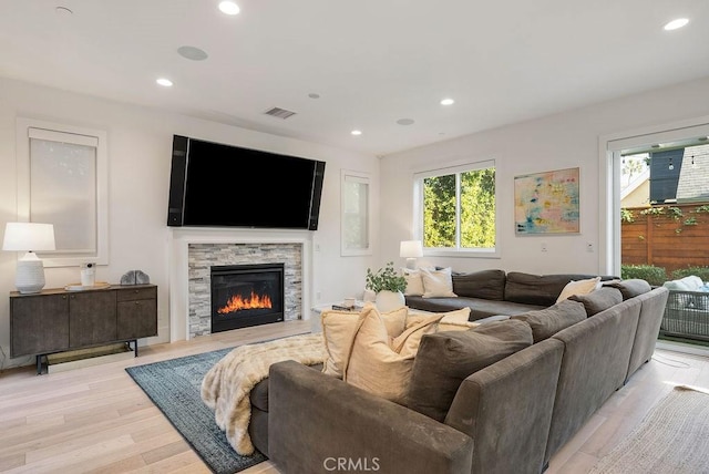 living room featuring a fireplace and light hardwood / wood-style floors