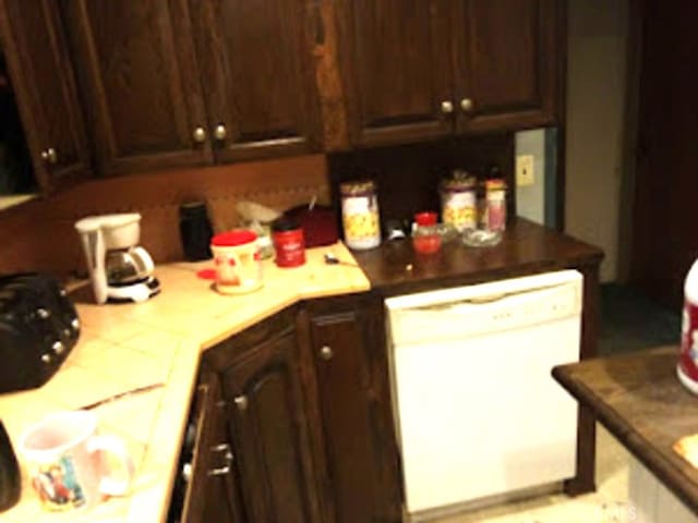 kitchen with white dishwasher and dark brown cabinets