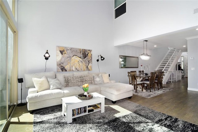 living room featuring hardwood / wood-style floors and a towering ceiling