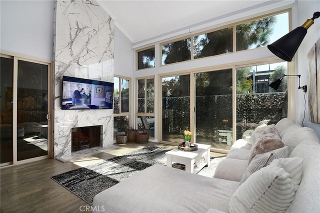 sunroom with lofted ceiling and a fireplace