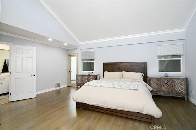 bedroom featuring dark wood-type flooring, connected bathroom, ornamental molding, and lofted ceiling