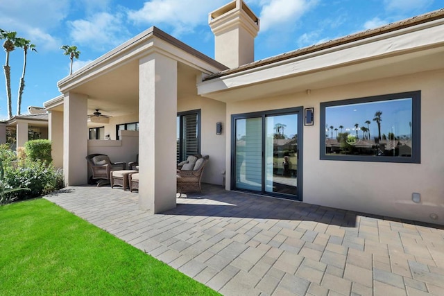 rear view of house with a patio area and ceiling fan