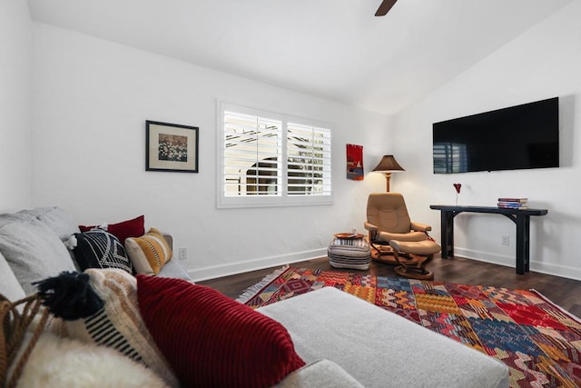 living room featuring dark hardwood / wood-style flooring and lofted ceiling