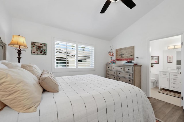 bedroom with lofted ceiling, ensuite bath, ceiling fan, and dark hardwood / wood-style flooring