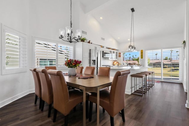 dining room featuring an inviting chandelier, high vaulted ceiling, and dark hardwood / wood-style flooring