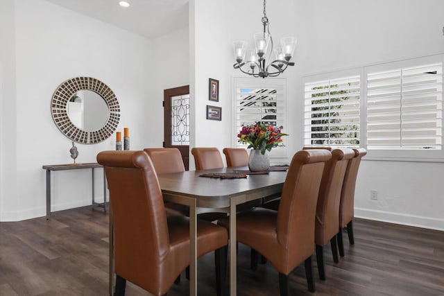 dining room featuring an inviting chandelier and dark wood-type flooring