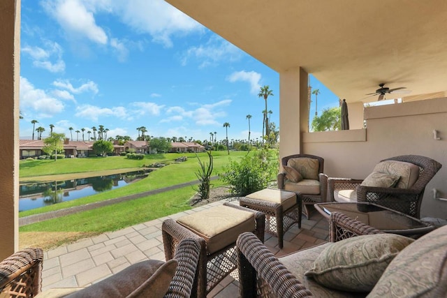 view of patio with ceiling fan and a water view