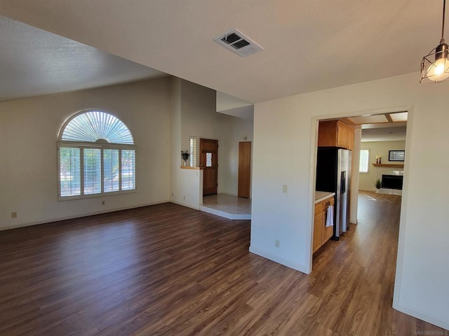 unfurnished living room with dark wood-type flooring