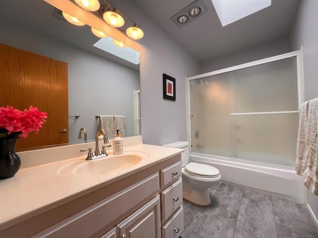 full bathroom featuring enclosed tub / shower combo, vanity, a skylight, and toilet