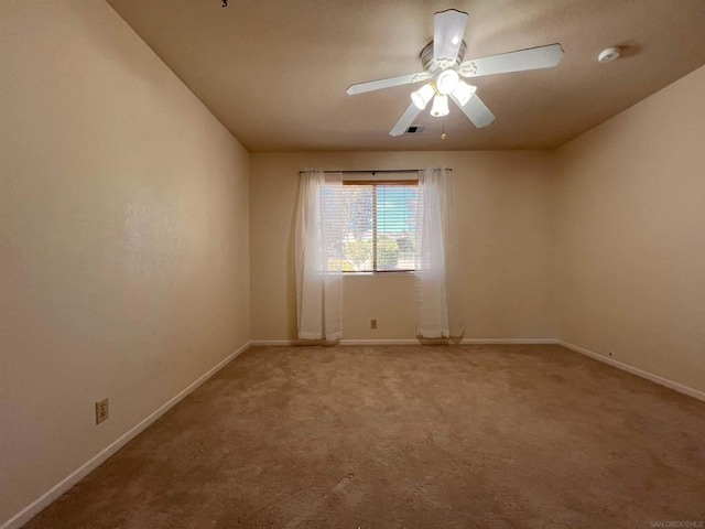 carpeted empty room featuring ceiling fan