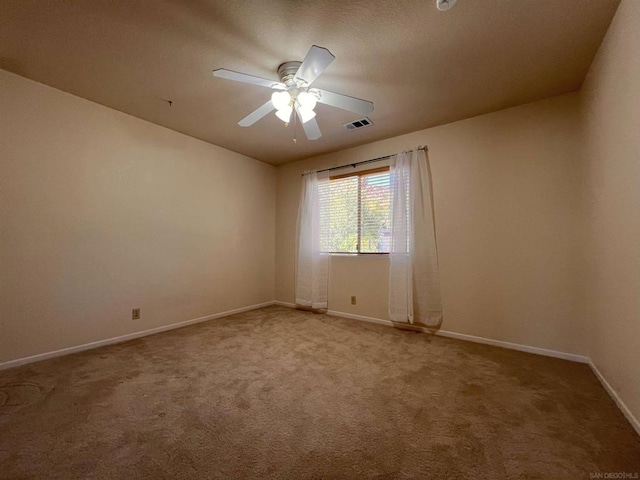 unfurnished room with ceiling fan and carpet flooring