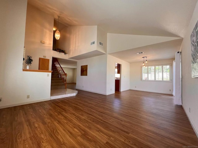 unfurnished living room with dark hardwood / wood-style flooring and high vaulted ceiling