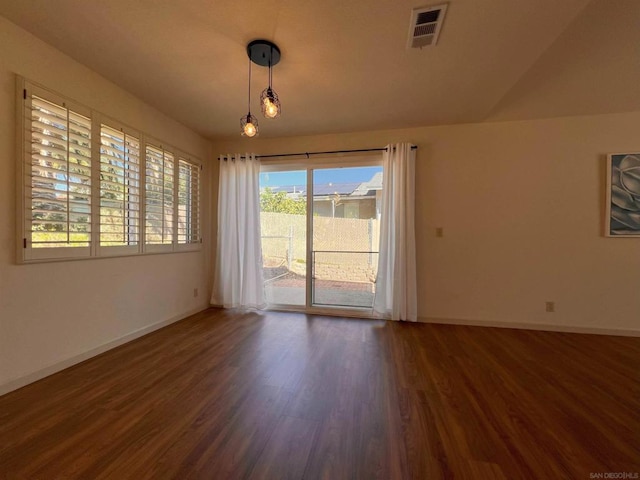 spare room featuring dark wood-type flooring