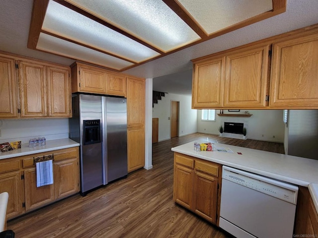 kitchen featuring stainless steel refrigerator with ice dispenser, dark wood-type flooring, and dishwasher