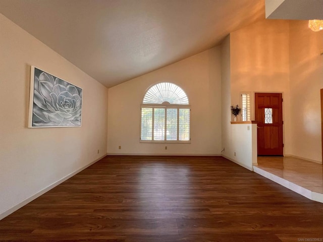 interior space with vaulted ceiling and dark hardwood / wood-style floors