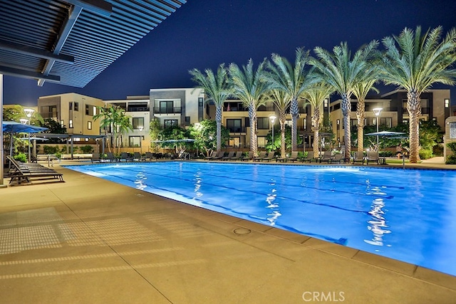 pool at night with a patio