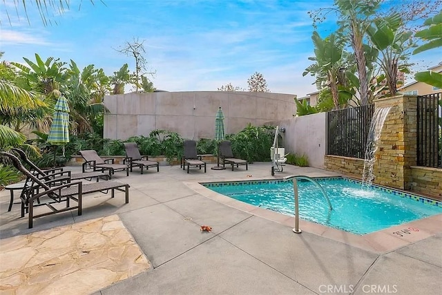 view of pool featuring pool water feature and a patio area