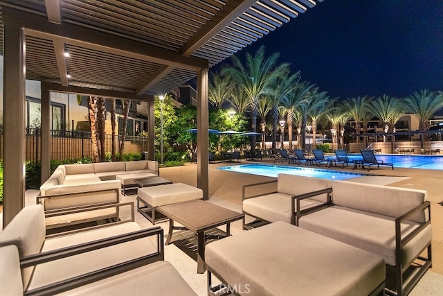 patio at twilight featuring an outdoor living space, a pergola, and a community pool