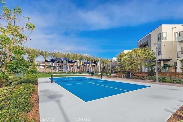 view of tennis court with basketball hoop