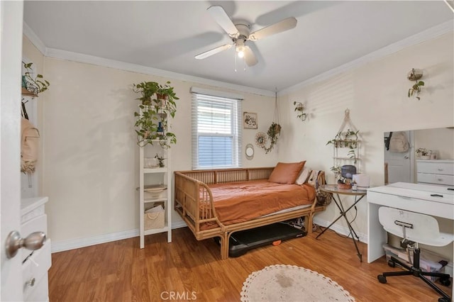 bedroom featuring ceiling fan, wood-type flooring, and ornamental molding