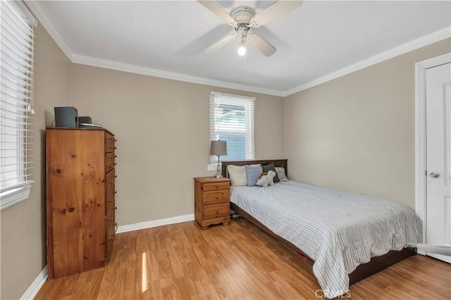 bedroom featuring ceiling fan, ornamental molding, and light hardwood / wood-style floors