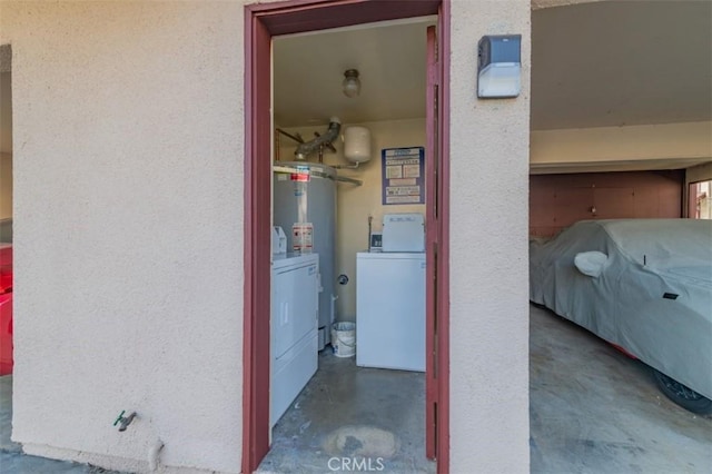 corridor with water heater and washing machine and clothes dryer