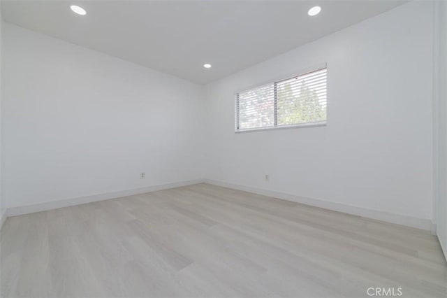 unfurnished room with light hardwood / wood-style flooring