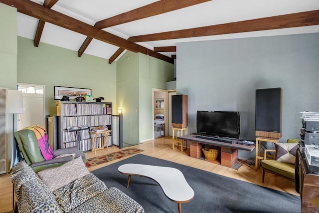 living room featuring high vaulted ceiling, beamed ceiling, and light wood-type flooring