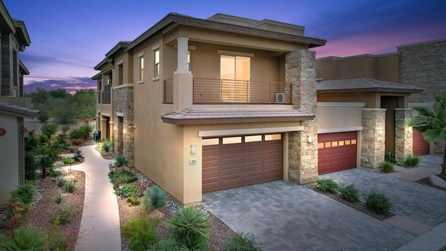 view of front of home with a balcony and a garage