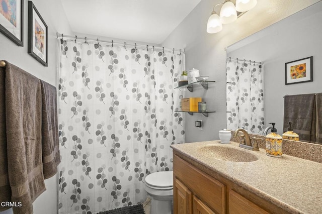 bathroom featuring toilet, a shower with curtain, and vanity