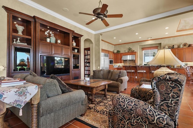 living room with ceiling fan, tile patterned floors, and ornamental molding