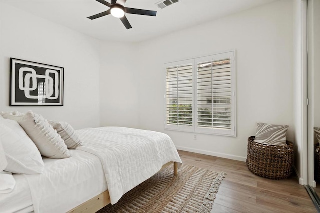 bedroom with ceiling fan and light hardwood / wood-style floors