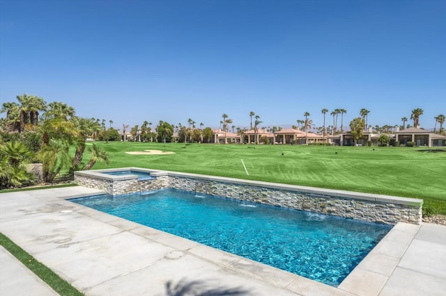 view of swimming pool featuring pool water feature, an in ground hot tub, a lawn, and a patio