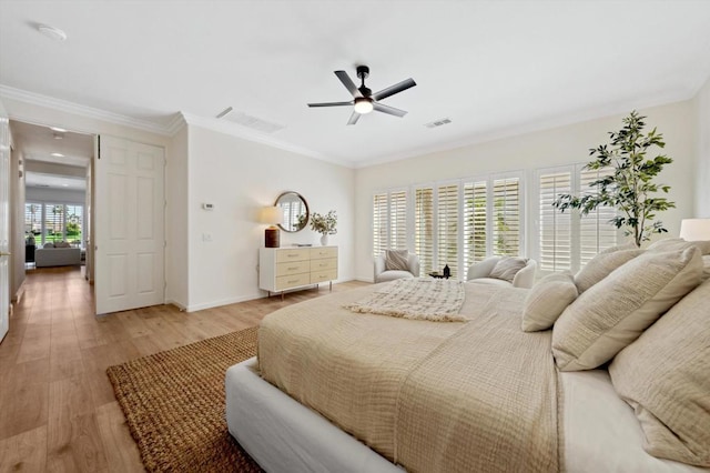 bedroom featuring ceiling fan, ornamental molding, and light hardwood / wood-style flooring