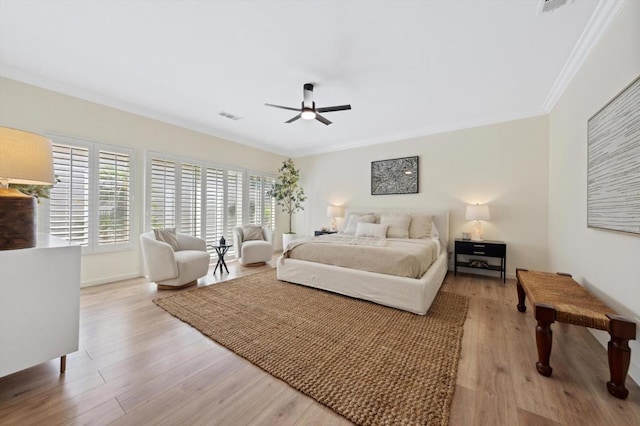 bedroom featuring ceiling fan, ornamental molding, and light hardwood / wood-style floors