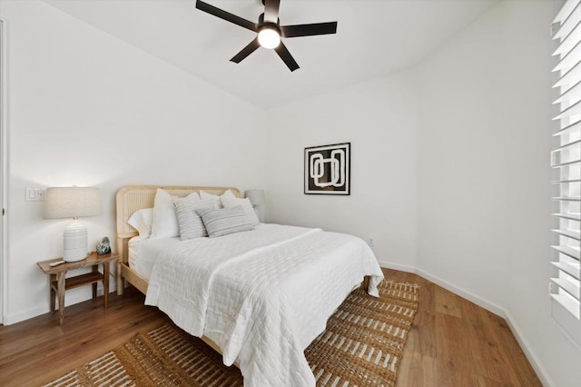 bedroom featuring ceiling fan and dark hardwood / wood-style flooring