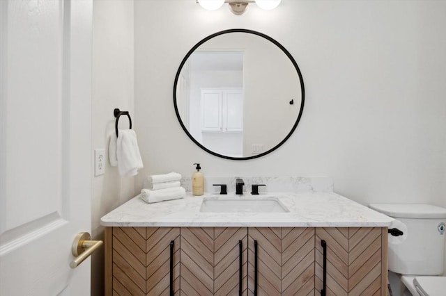 bathroom with toilet and vanity