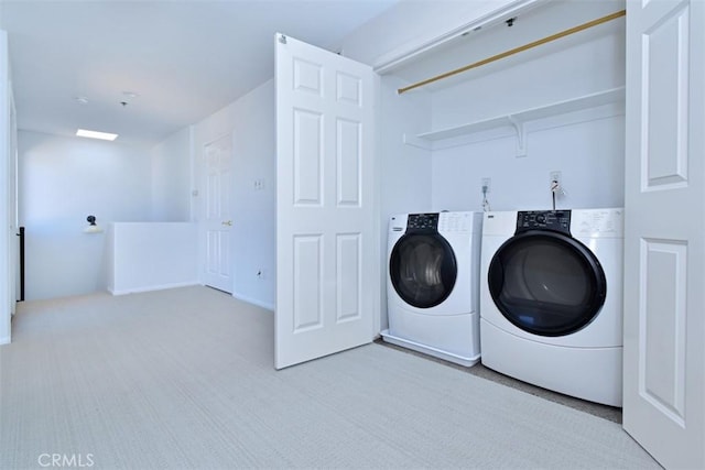 washroom with light colored carpet and washing machine and clothes dryer