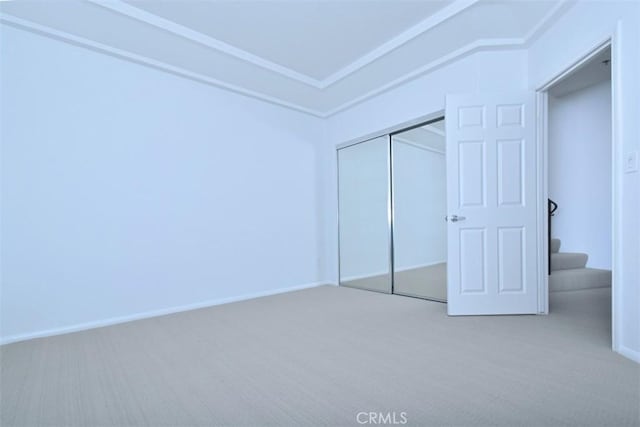 unfurnished bedroom featuring carpet and a closet