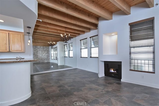 unfurnished living room with wooden ceiling, beam ceiling, and a notable chandelier