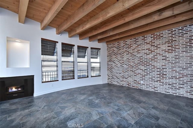 unfurnished living room with wooden ceiling, brick wall, and beam ceiling