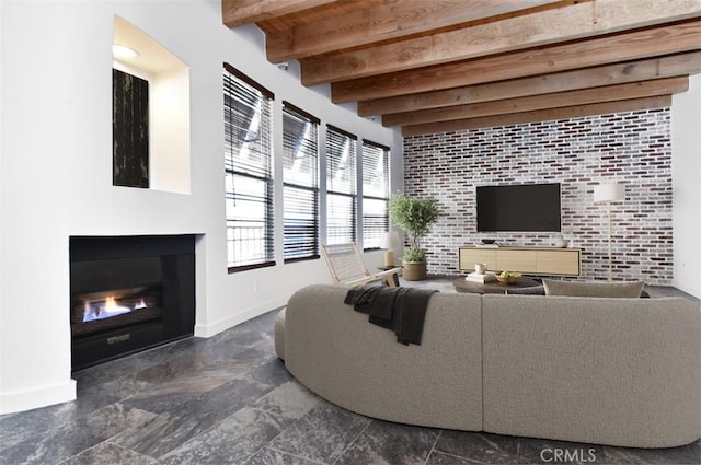 living room with brick wall and beam ceiling